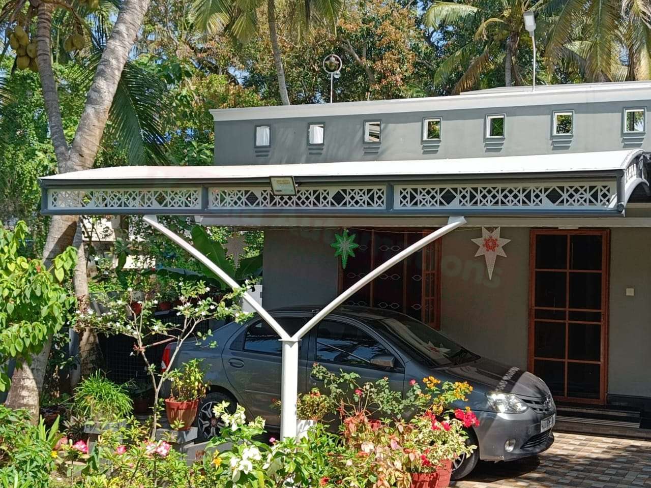 Modern tensile car porch design built in Alappuzha, Kerala using latest cantilever and roofing styles