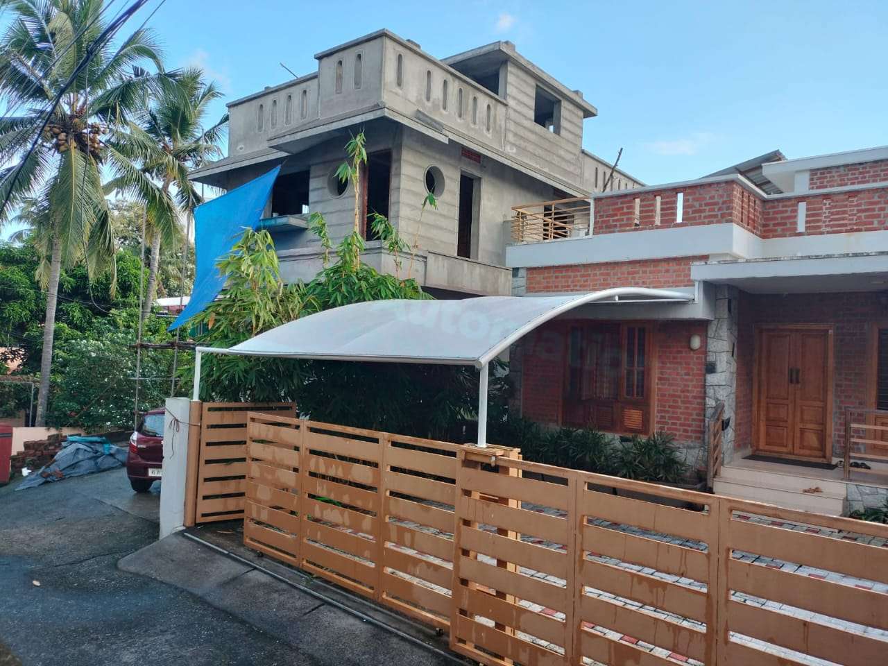 Modern tensile car porch design built in Ambalappuzha, Kerala using latest cantilever and roofing styles