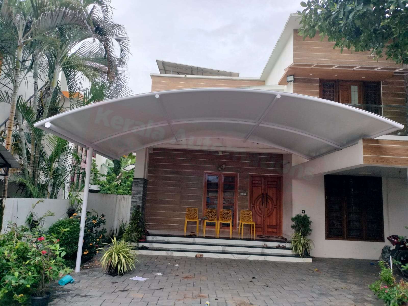 Modern tensile car porch design built in Chengannur, Kerala using latest cantilever and roofing styles