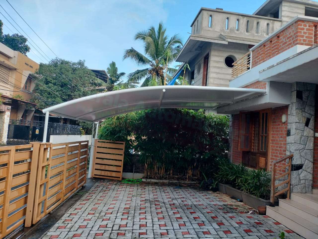 Modern tensile car porch design built in Cherthala, Kerala using latest cantilever and roofing styles