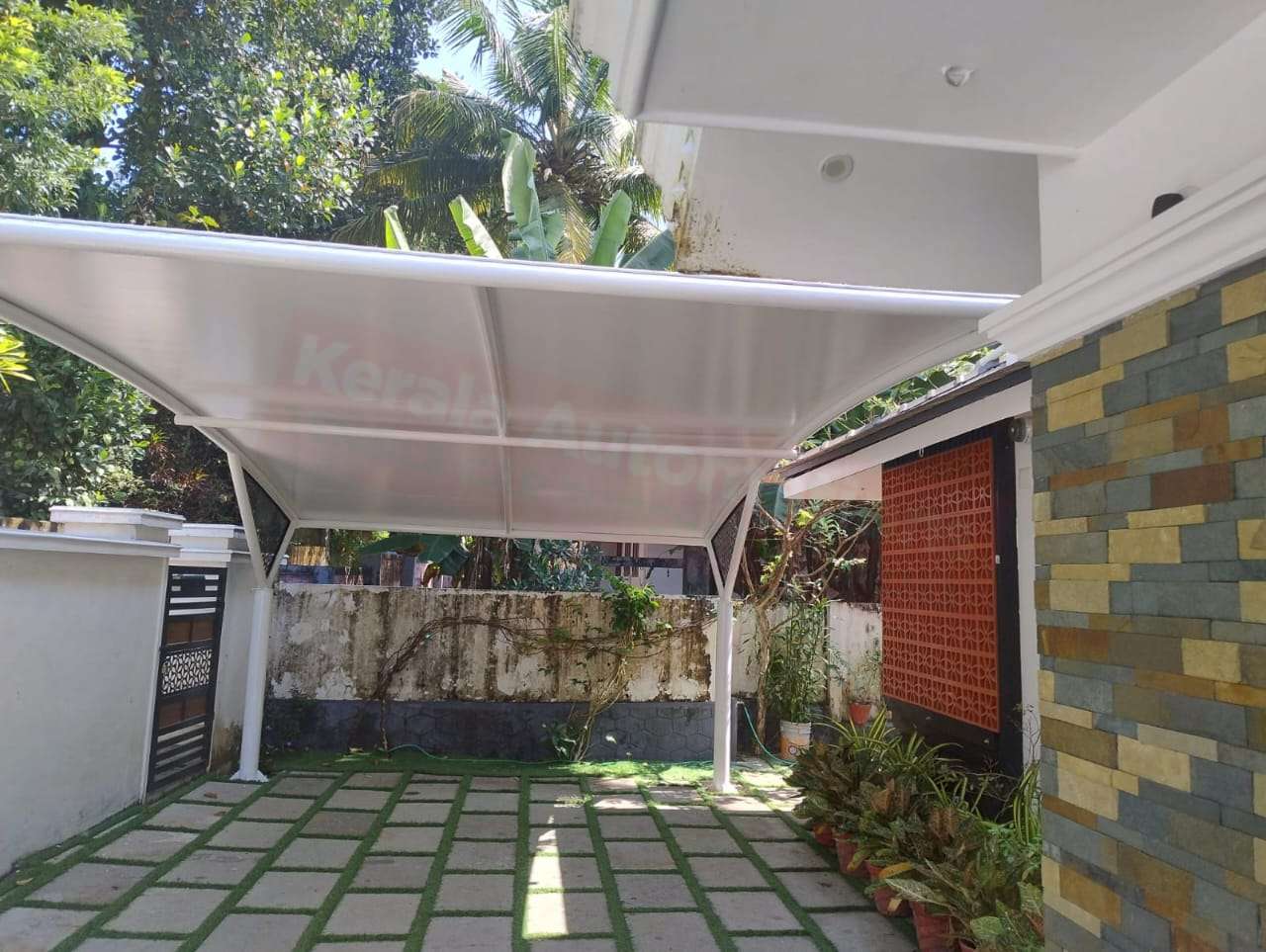 Modern tensile car porch design built in Haripad, Kerala using latest cantilever and roofing styles