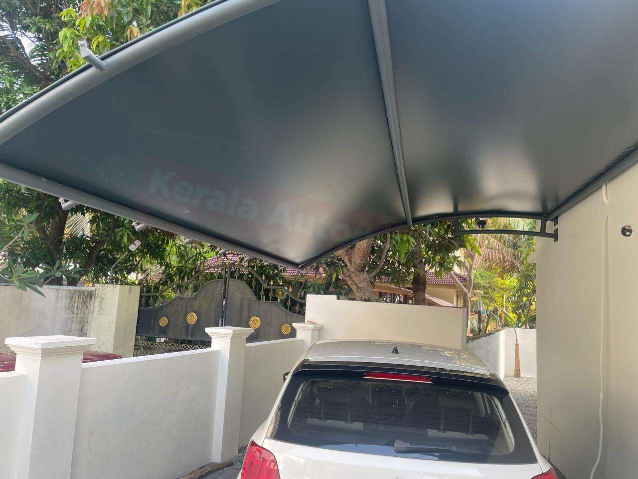 Modern tensile car porch design built in Kayamkulam, Kerala using latest cantilever and roofing styles