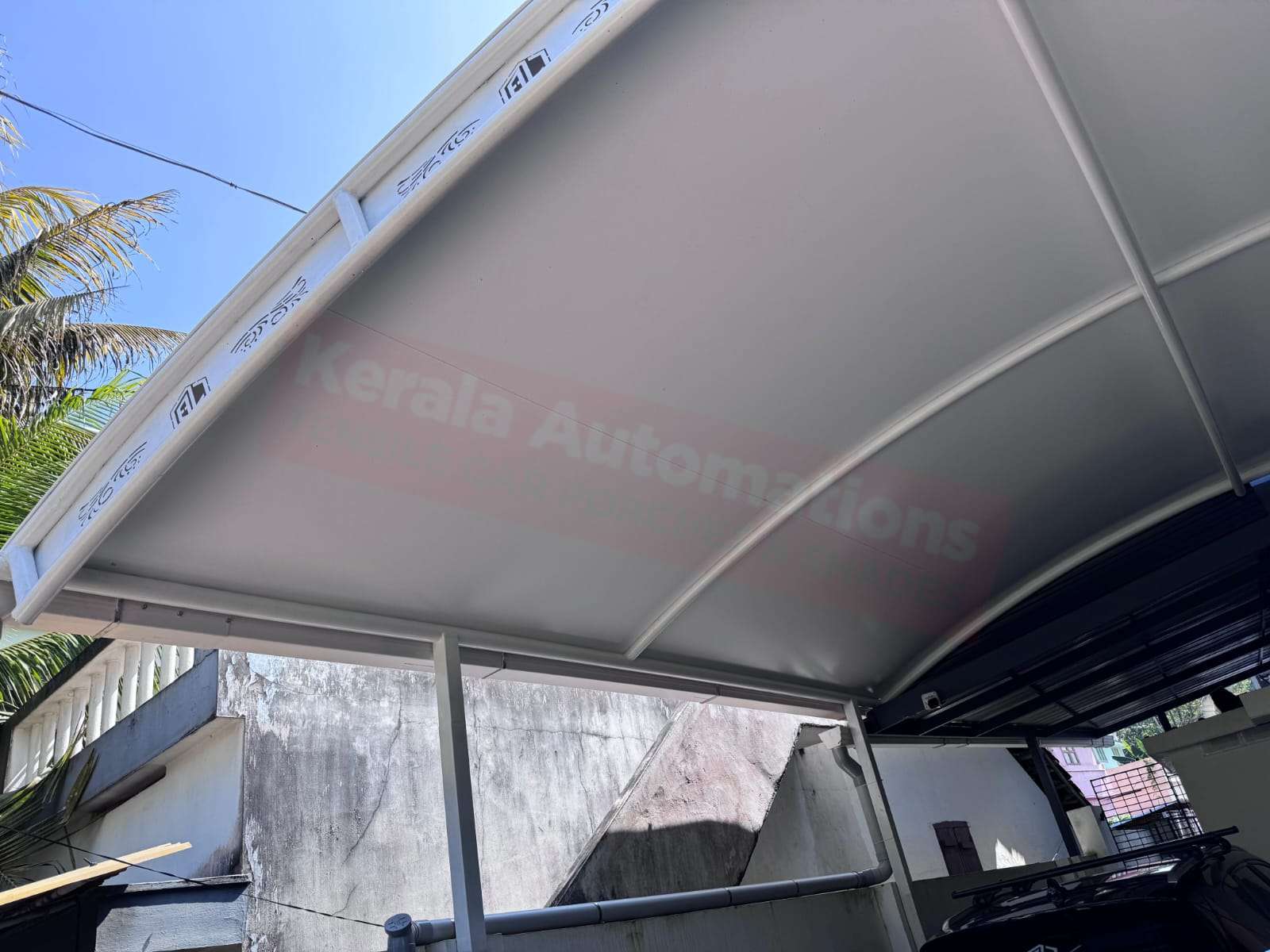 Modern tensile car porch design built in Kilimanoor, Kerala using latest cantilever and roofing styles