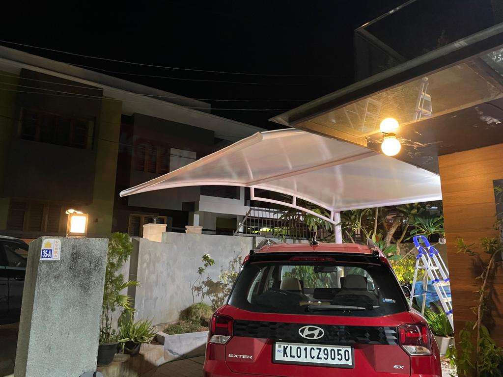Modern tensile car porch design built in Kollam, Kerala using latest cantilever and roofing styles