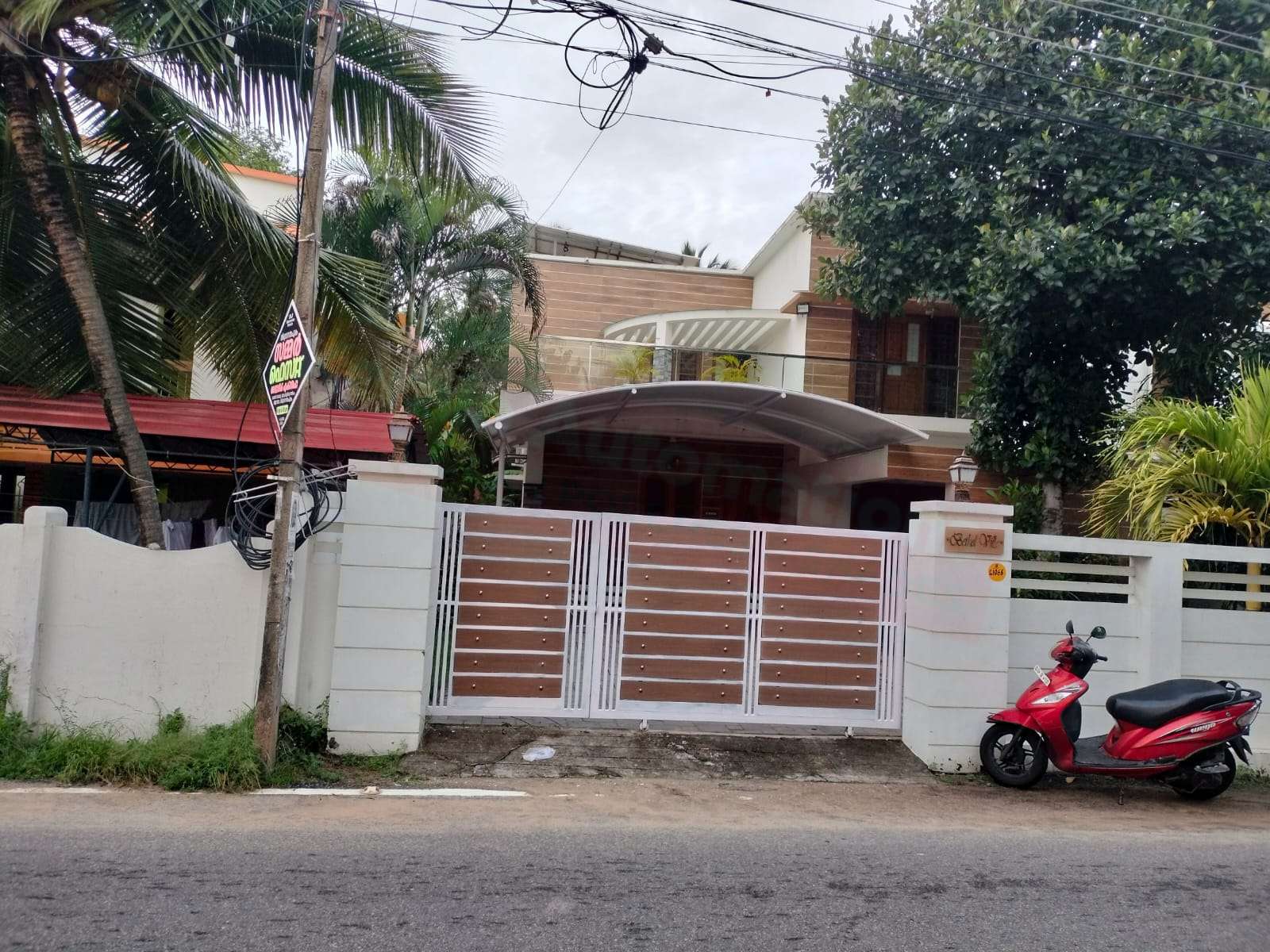 Modern tensile car porch design built in Mavelikkara, Kerala using latest cantilever and roofing styles