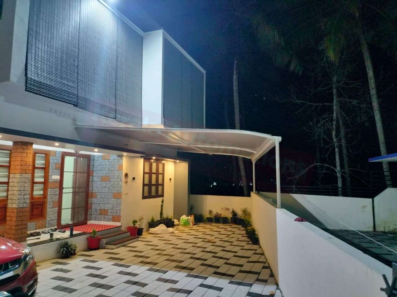 Modern tensile car porch design built in Neyyattinkara, Kerala using latest cantilever and roofing styles