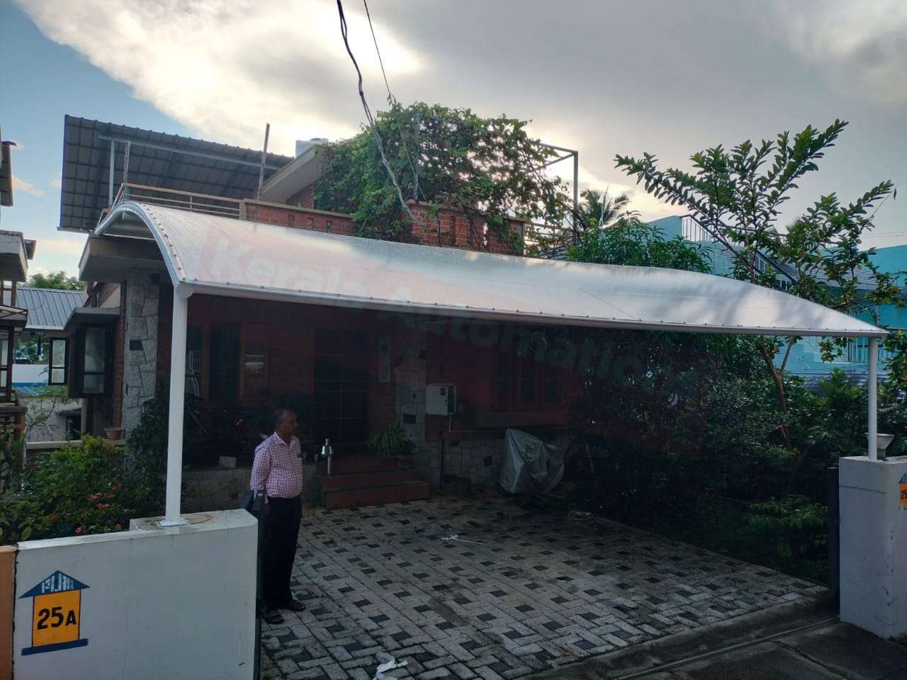 Modern tensile car porch design built in Paravur, Kerala using latest cantilever and roofing styles