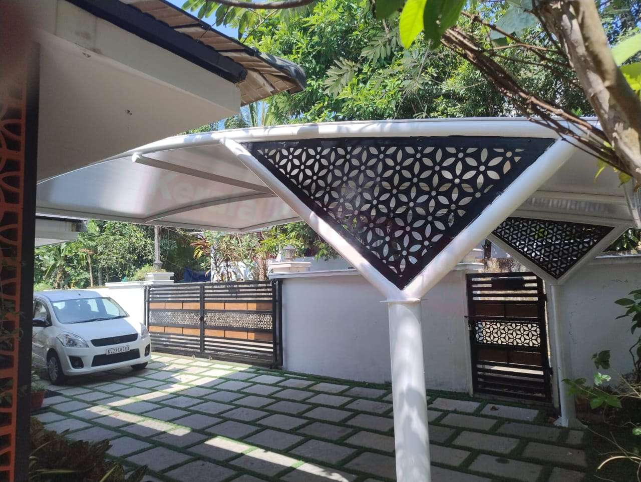 Modern tensile car porch design built in Pathanamthitta, Kerala using latest cantilever and roofing styles