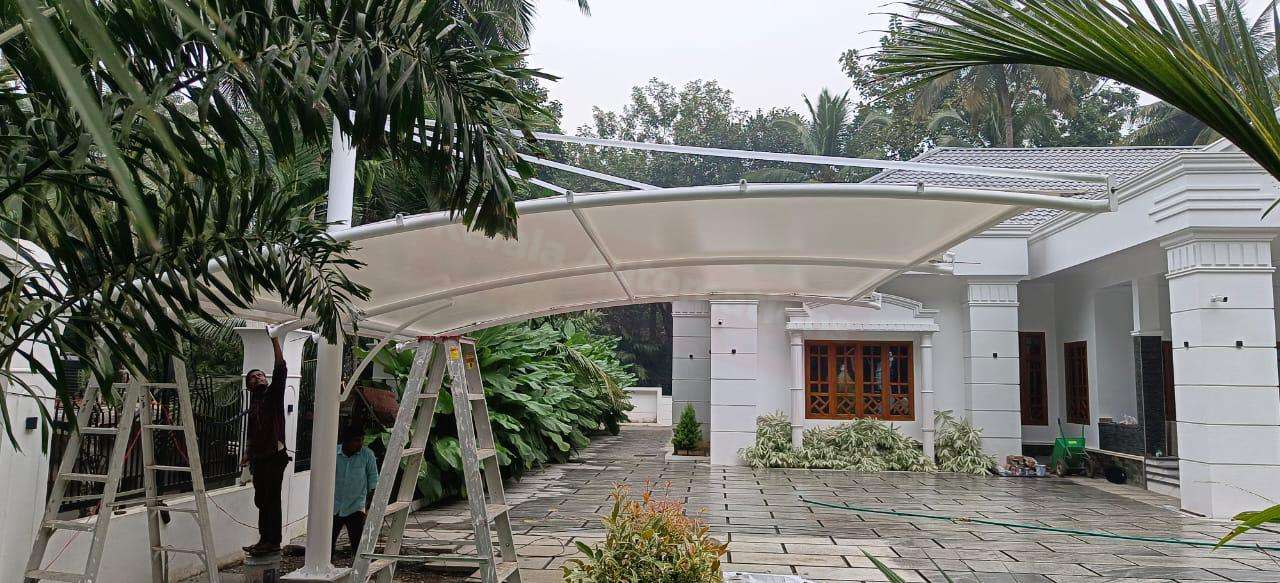 Modern tensile car porch design built in Punalur, Kerala using latest cantilever and roofing styles