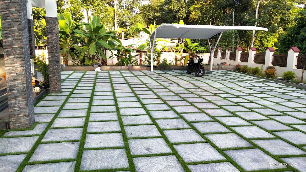 Modern tensile car porch design built in Thiruvalla, Kerala using latest cantilever and roofing styles
