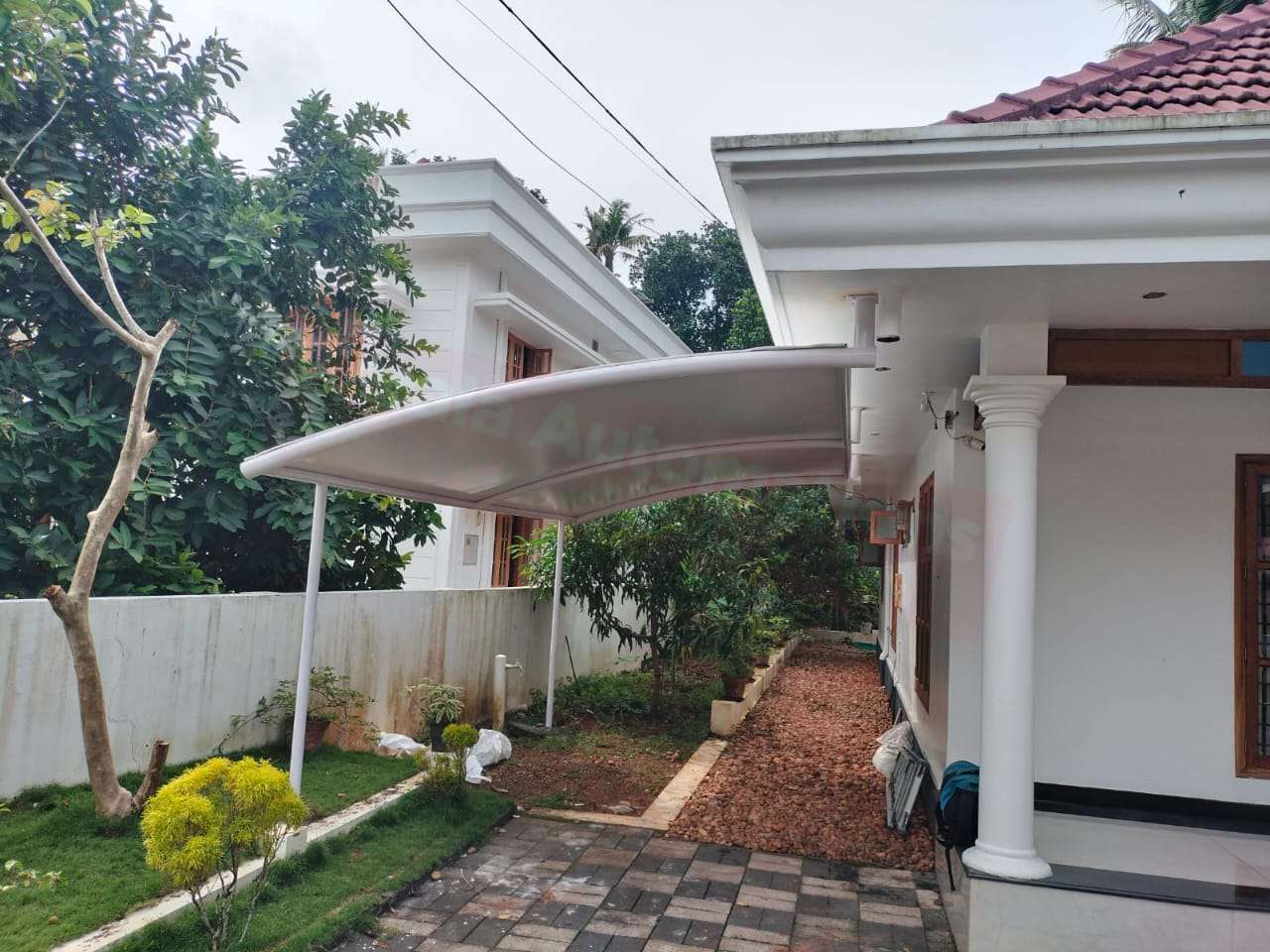 Modern tensile car porch design built in Trivandrum, Kerala using latest cantilever and roofing styles