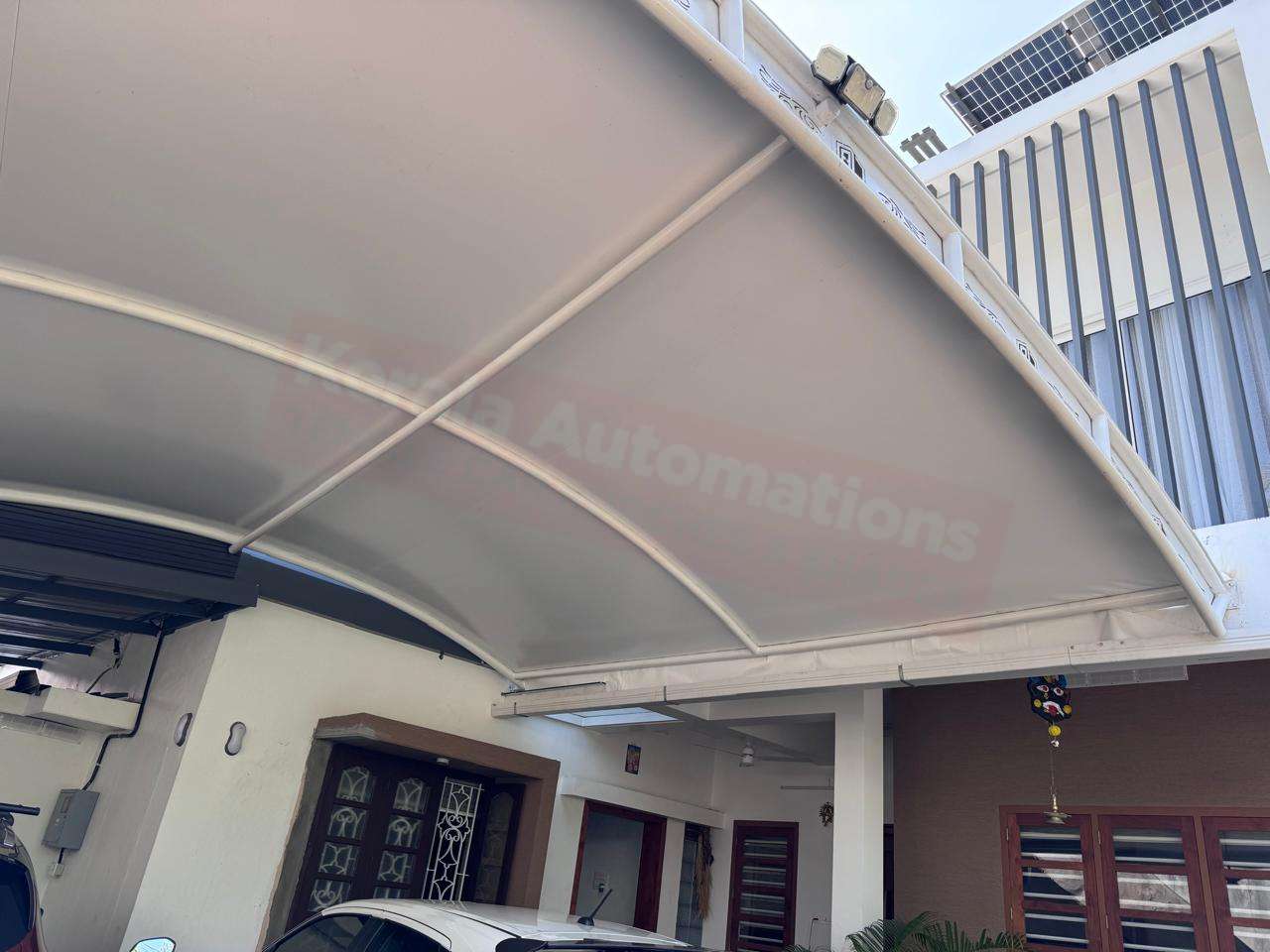 Modern tensile car porch design built in Varkala, Kerala using latest cantilever and roofing styles